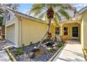 Close up of front entrance of a charming home, with pond and Florida landscaping at 406 116Th E St, Bradenton, FL 34212