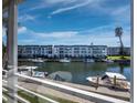 Scenic water view from a condo featuring boats docked along a canal in front of the building at 4400 Exeter Dr # J-201, Longboat Key, FL 34228