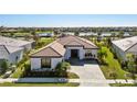 Aerial shot of a well-manicured single-story home that is close to the lake, with a paver driveway at 4609 Antrim Dr, Sarasota, FL 34240
