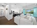 Open concept living area features hardwood flooring, modern lighting and access to the outdoor patio at 4609 Antrim Dr, Sarasota, FL 34240