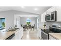 Modern kitchen showcasing stainless steel appliances and a seamless view into the dining area at 4860 Wilcox Ave, North Port, FL 34288