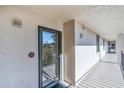 Exterior hallway with view of the surrounding tropical landscaping from the front door at 6263 Midnight Pass Rd # 105, Sarasota, FL 34242