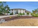 Beautiful two-story home featuring large windows, stone accents, and lush landscaping in a lovely neighborhood at 7912 Desoto Memorial Hwy, Bradenton, FL 34209