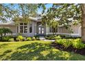 Charming home featuring a beautifully landscaped front yard and a welcoming entryway at 8579 Woodbriar Dr, Sarasota, FL 34238