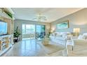 Comfortable living room featuring tile floors, white furniture, and natural light at 1200 E Peppertree Ln # 305, Sarasota, FL 34242