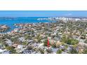 Scenic aerial shot of a neighborhood with waterfront views and a city skyline in the distance at 1687 Arlington St, Sarasota, FL 34239