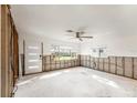 Spacious living room featuring large windows offering plenty of natural light and a ceiling fan at 1719 New Hampshire Ne Ave, St Petersburg, FL 33703