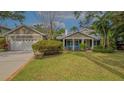 Charming home with two rocking chairs on front porch and attached garage at 1919 Irving St, Sarasota, FL 34236