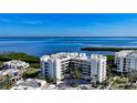 Coastal condo building featuring manicured grounds and stunning views of the bay at 1932 Harbourside Dr # 244, Longboat Key, FL 34228