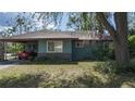 Cozy home featuring a covered carport and a well-manicured lawn, blending comfort and convenience at 2784 Martin St, Sarasota, FL 34237