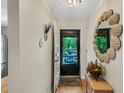 Bright entryway features a decorative mirror and an open door to the outside at 2961 Taywood Mdws # 26, Sarasota, FL 34235