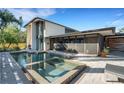 Backyard pool and spa with a screened lanai and modern architecture at 3026 Mayflower St, Sarasota, FL 34231