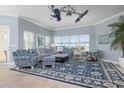 Coastal living room with blue patterned furniture, large windows, and ocean views at 3404 79Th Street W Cir # 301, Bradenton, FL 34209