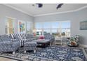 Living area featuring striped couch, patterned chairs, and a colorful parrot painting at 3404 79Th Street W Cir # 301, Bradenton, FL 34209