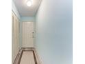 Bright hallway with a white front door, neutral rug, closet, and light blue walls at 4061 Crockers Lake Blvd # 2611, Sarasota, FL 34238