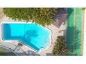 Overhead shot of a well-maintained community pool next to a shuffleboard court at 4307 Gulf Dr # 208, Holmes Beach, FL 34217