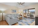 Bright living area featuring a comfortable sofa and sliding glass doors to the pool at 4411 Violet Ave, Sarasota, FL 34233