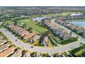 Stunning aerial view showcasing an expansive community with well-manicured lawns, serene lakes, and a golf course at 4543 Terrazza Ct, Lakewood Ranch, FL 34211