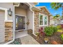 Inviting front entrance with stone accents, decorative wreath, and well-maintained landscaping at 5821 Hevena Ct, Palmetto, FL 34221