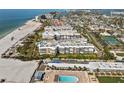 An aerial view of the condo complex by the beach, revealing a pool and recreation area at 6500 Sunset Way # 311, St Pete Beach, FL 33706