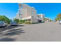 Condo building exterior featuring private balconies, with well-maintained landscaping at 6500 Sunset Way # 311, St Pete Beach, FL 33706