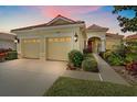 Charming home exterior featuring a well-manicured lawn, vibrant plants, and a two-car garage at 6540 Tailfeather Way, Bradenton, FL 34203