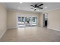 Spacious living room featuring tile flooring and sliding glass doors to the enclosed lanai at 6705 20Th W Ave, Bradenton, FL 34209