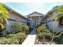 Inviting home entrance featuring a tiled pathway and lush landscaping at 746 Plymouth St, Sarasota, FL 34242