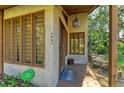 Inviting front entrance with textured walls, wood accents, and a 'Gone to the Beach' welcome mat at 7921 4Th W Ave, Bradenton, FL 34209