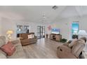 Cozy living room with wood floors, ceiling fan and plenty of natural light at 8536 Countess Avenue Cir, Palmetto, FL 34221