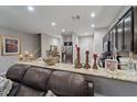 Kitchen view features granite countertops, a breakfast bar, and stainless steel appliances at 1038 Grantham Dr, Sarasota, FL 34234