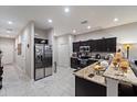 Well-lit kitchen features stainless steel appliances, granite countertops and tile flooring at 1038 Grantham Dr, Sarasota, FL 34234