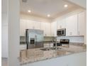Modern kitchen with stainless steel appliances and granite countertops at 14906 Lyla Ter, Bradenton, FL 34211