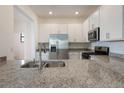 Bright kitchen featuring stainless appliances, granite counters and ample cabinet space at 14906 Lyla Ter, Bradenton, FL 34211