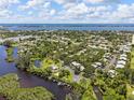 Stunning aerial view of a waterfront community with lush landscaping and a beautiful bay at 155 Jose Gaspar Dr # 155, Englewood, FL 34223