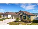 Attractive home featuring a three-car garage, verdant lawn, and well-kept landscaping at 1901 Everson St, Bradenton, FL 34208