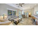 Open-concept living room features recessed lighting, ceiling fan, and views into the dining area at 2047 Roselawn St, Sarasota, FL 34231