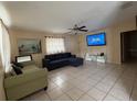 Spacious living room features neutral walls, tile flooring and a ceiling fan, creating a welcoming atmosphere at 3305 13Th W Ave, Bradenton, FL 34205