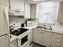 Charming kitchen featuring white appliances and ample cabinet space at 3528 Lake Bayshore Dr # K-115, Bradenton, FL 34205