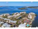 Aerial view of waterfront homes featuring private docks, boats, tennis court and a community pool at 3850 Mariners Walk # 713, Cortez, FL 34215