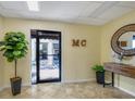 Bright, inviting lobby area enhanced by a decorative mirror, plant, and coastal decor at 3850 Mariners Walk # 713, Cortez, FL 34215