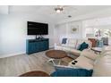 Comfortable living room showcasing wood floors and an open concept design to the kitchen at 400 Dona Dr, Nokomis, FL 34275