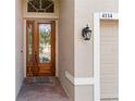 Close-up of an ornate wooden front door with sidelights and decorative glass at 4114 63Rd E Ter, Sarasota, FL 34243