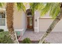 Elegant front entryway with a beautiful wood door and a brick-paved walkway at 4114 63Rd E Ter, Sarasota, FL 34243