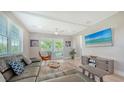 Cozy living room featuring a comfortable leather sofa and sliding glass doors at 4207 Marina View Way, Cortez, FL 34215