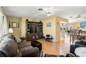 Open-concept living room with wood-look floors that seamlessly connects to the dining area at 45 Englewood Heights Rd, Englewood, FL 34223