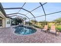 Inviting screened pool with scenic views of the golf course and lounge chairs at 5529 Mulligan Way, Bradenton, FL 34211