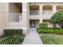 Welcoming condo entrance with well-maintained landscaping and a private balcony, creating a serene outdoor space at 6326 Grand Oak Cir # 101, Bradenton, FL 34203