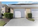 Attached one car garage with concrete driveway and well-maintained landscaping in front of residential building at 6326 Grand Oak Cir # 101, Bradenton, FL 34203
