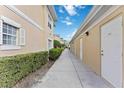 Exterior walkway featuring a well maintained sidewalk with access to units and private entryways at 6326 Grand Oak Cir # 101, Bradenton, FL 34203